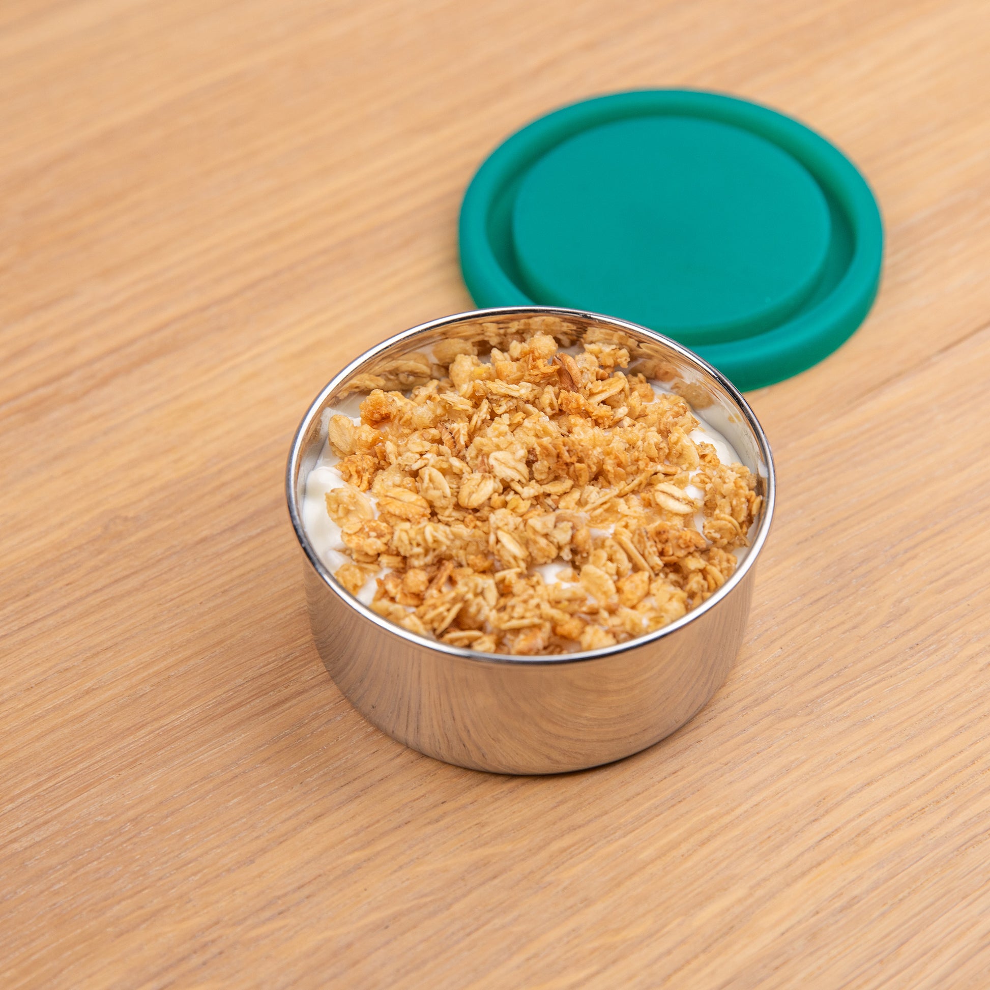 RVS snackbox gevuld met yoghurt en musli.